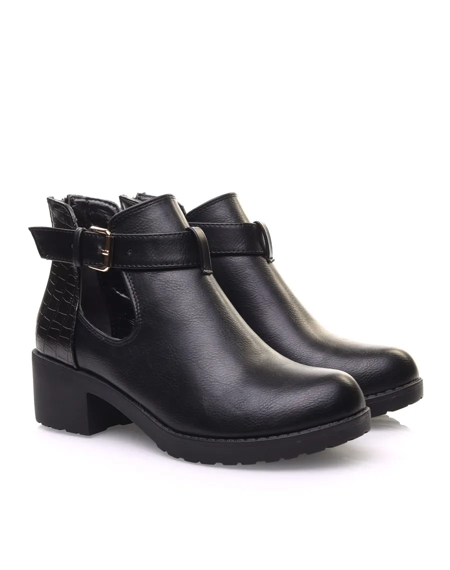 Black cutout ankle boots with small heel and buckle.