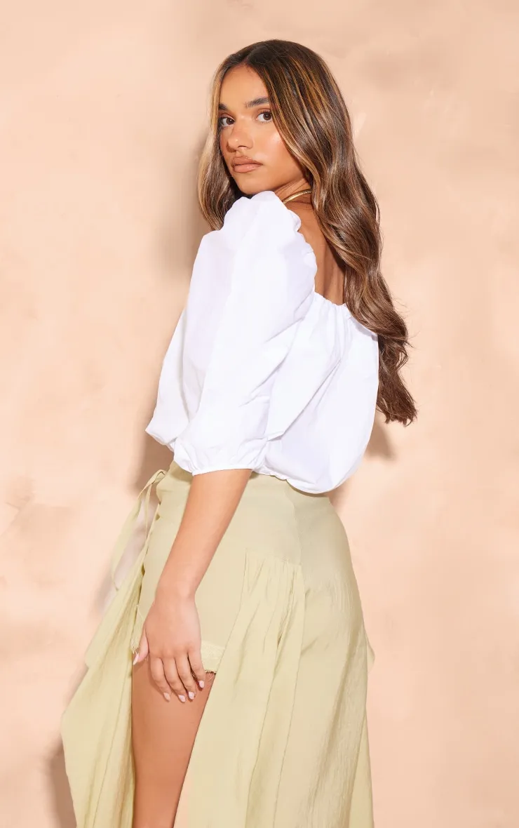 Long white poplin top with puff sleeves.