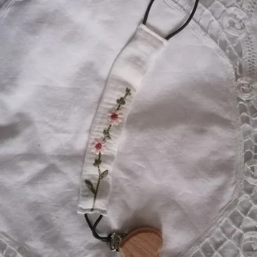 Spring embroidered pacifier clip.
